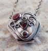 "Silver and garnet locket"